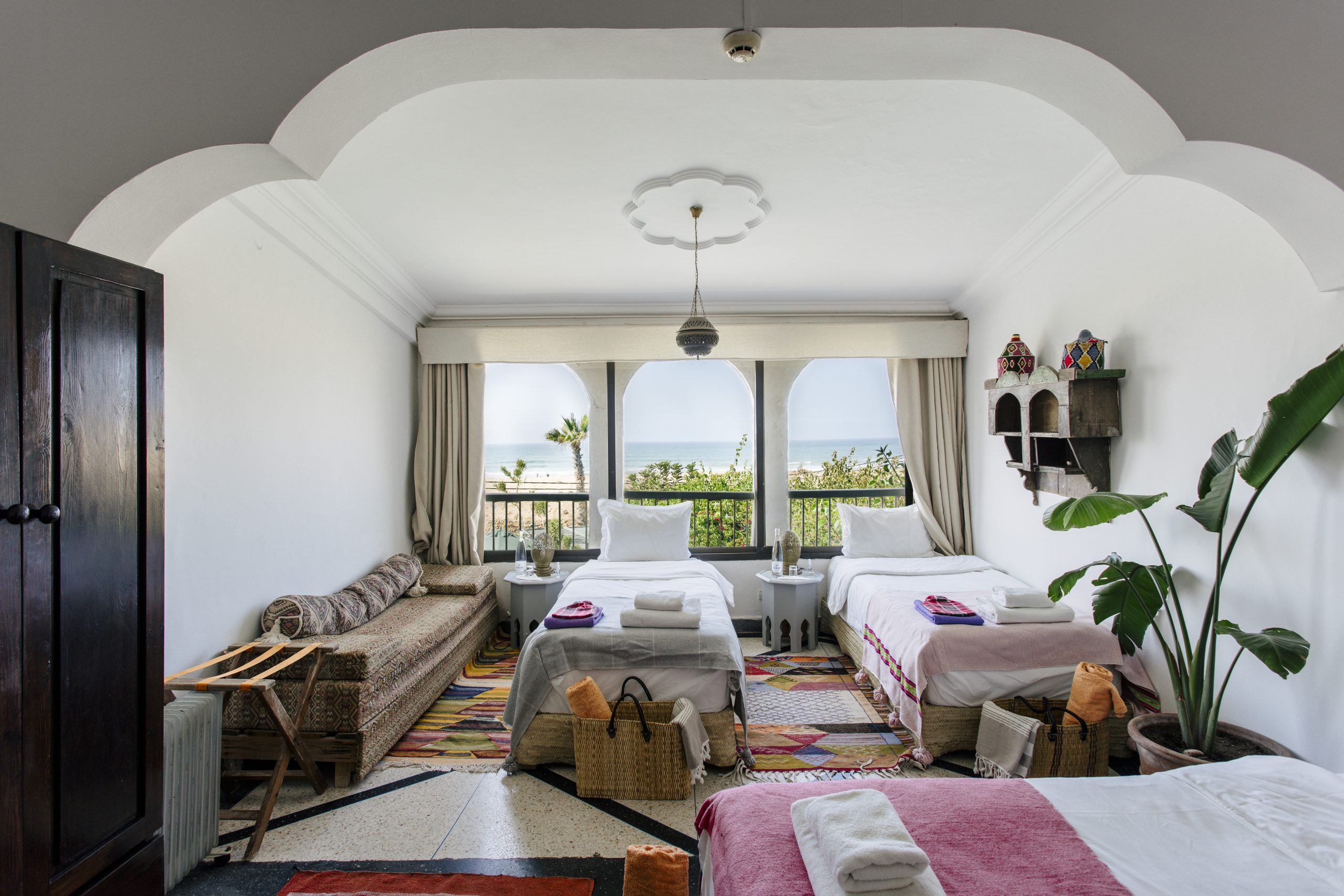 Shared ocean-view bedroom with twin beds at Villa Mandala